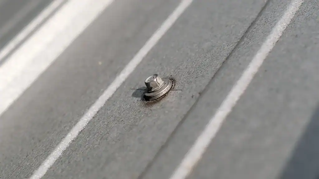 Close up of fastener on commercial metal roof