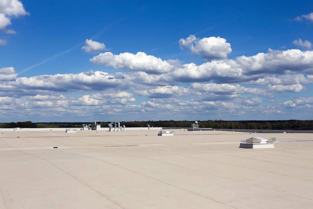 Commercial flat roofing system, featuring a durable, multi-layered membrane designed to provide superior waterproofing, energy efficiency, and long-term protection against the elements for industrial buildings.