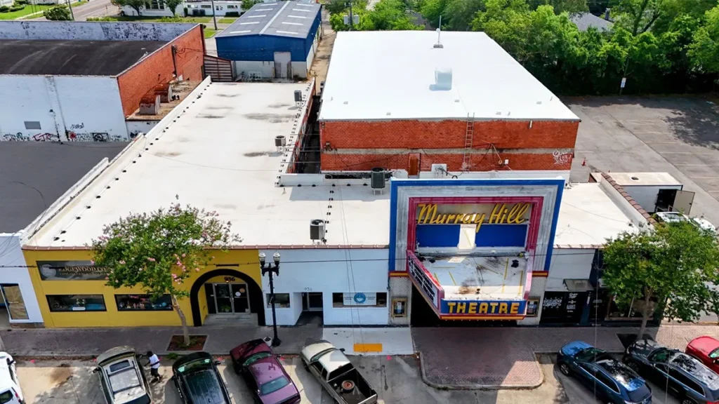 Aerial drone image of small theatre with Envir-O-Sil roof restoration system, providing seamless, flexible waterproofing protection.
