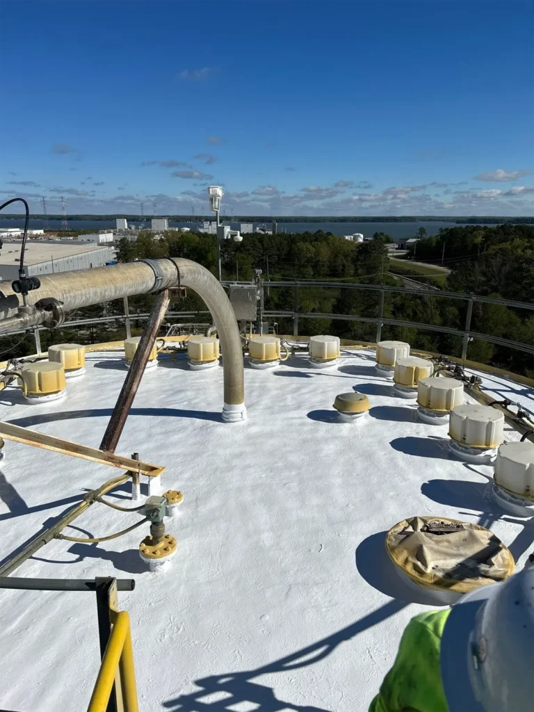 Spray foam system applied to a water tower, providing an insulating layer for improved temperature control and long-term protection.