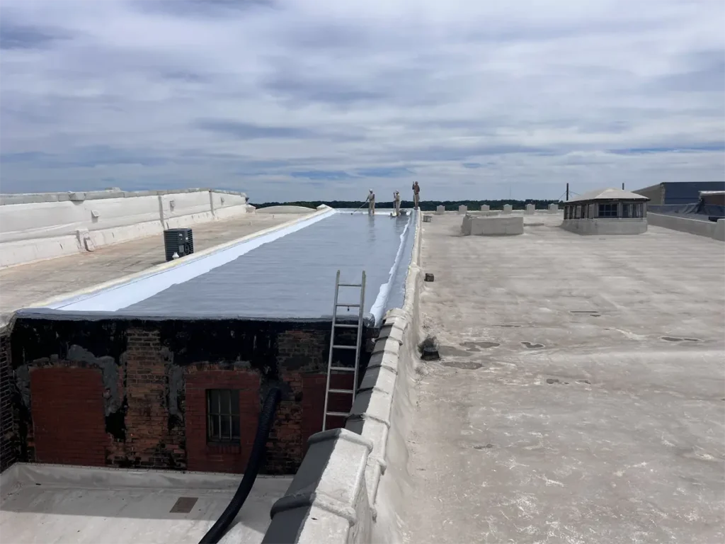 Urethane being applied to the roof before the top coat, creating a protective base layer for enhanced durability and waterproofing.