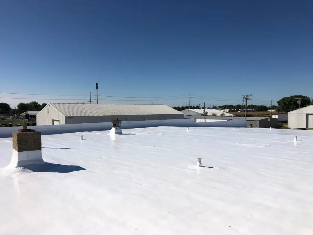 Flat roof with spray foam applied, providing a seamless, insulating layer for enhanced energy efficiency and waterproofing.