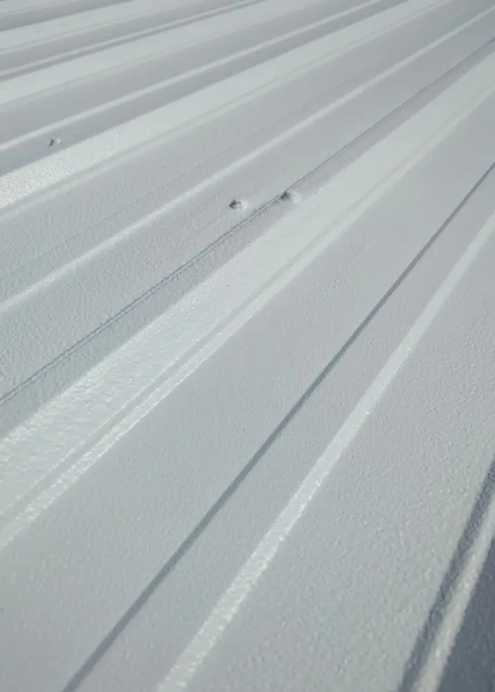 Close-up shot of Met-A-Gard's Acrylic 211 top coat, showcasing the seamless and highly reflective coating membrane.white