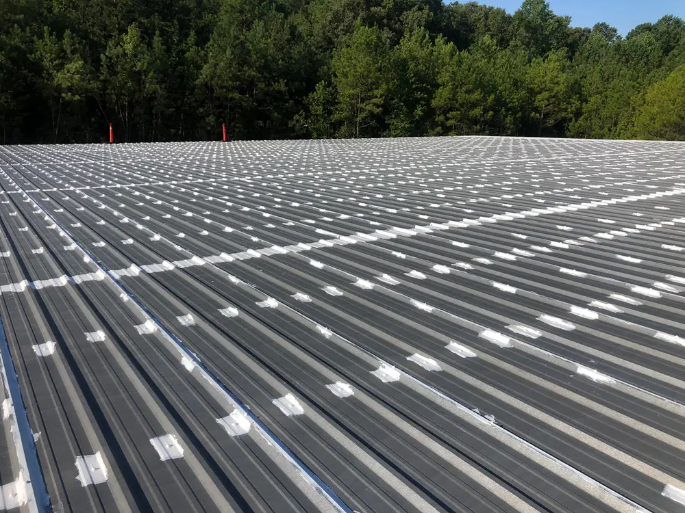 Broad view of Acrylic Brush-Grade 220 and Acrylic Butter-Grade 221 roofing mastic on horizontal seams and fasteners.