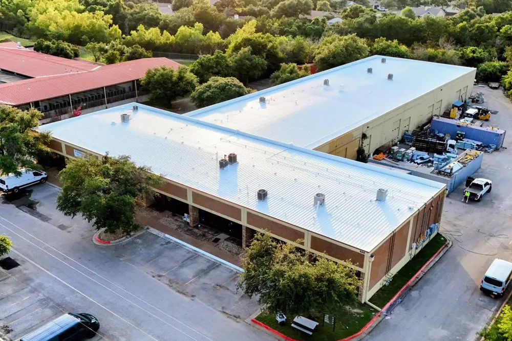 Aerial view of commercial metal roof with newly-installed top coat of Acrylic 211.