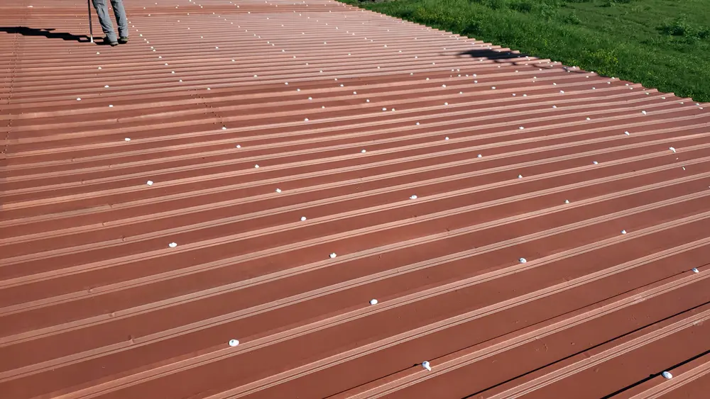 R-panel metal roof with primer (Red Oxide Rust Prime 912) and waterproofed fasteners (Acrylic Brush-Grade 220) for rust and moisture protection.