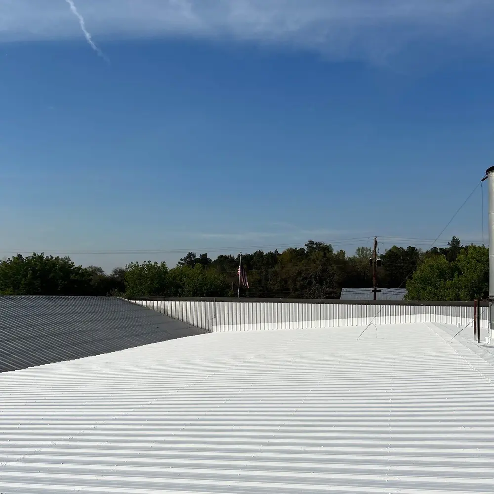 Wide-angle image of top coat application (Acrylic 211) of the Met-A-Gard system, giving a seamless, weather-resistant, and durable membrane.