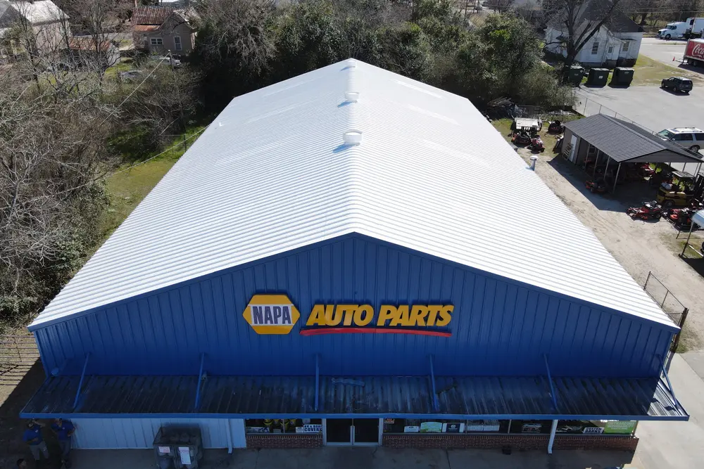 Aerial view of a nationally known auto parts retail store featuring the Met-A-Gard system's top coat (Acrylic 211), showing its seamless, bright-white finish.