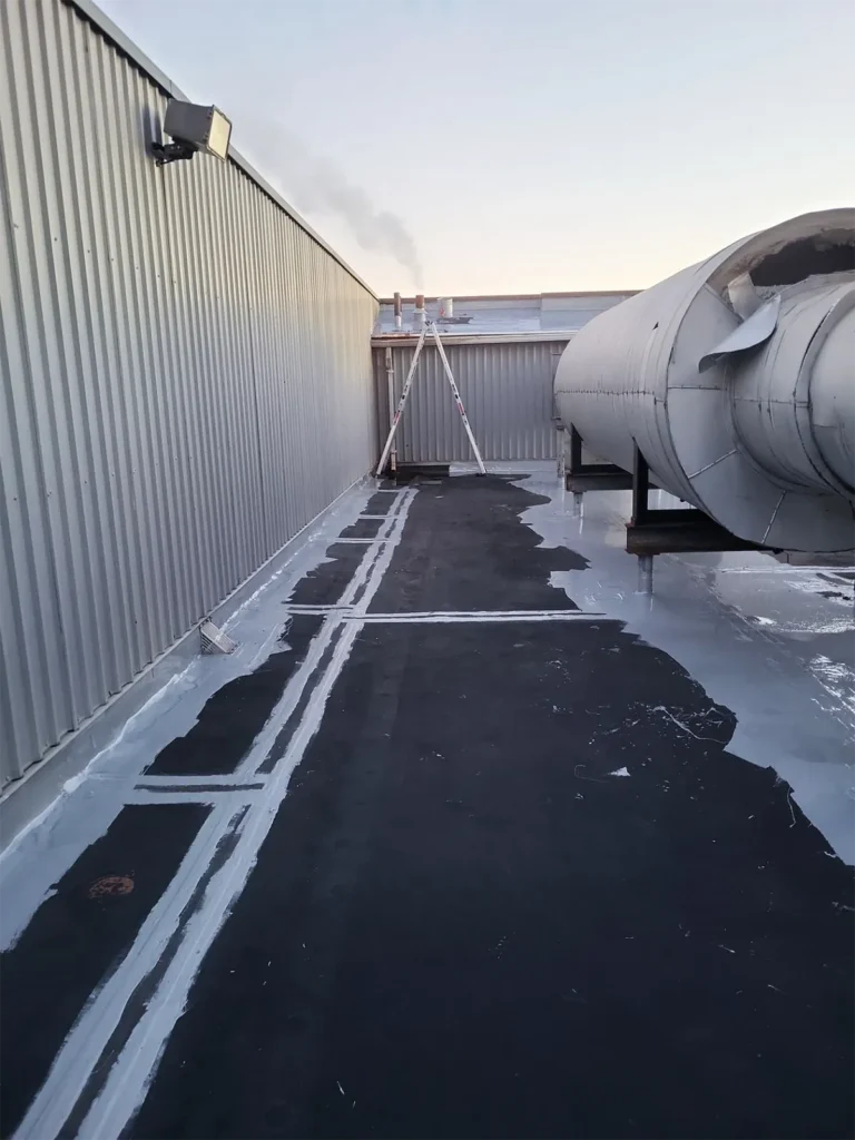 Progress shot of seams and other details treated with low-VOC urethane brush-grade waterproofing mastic.