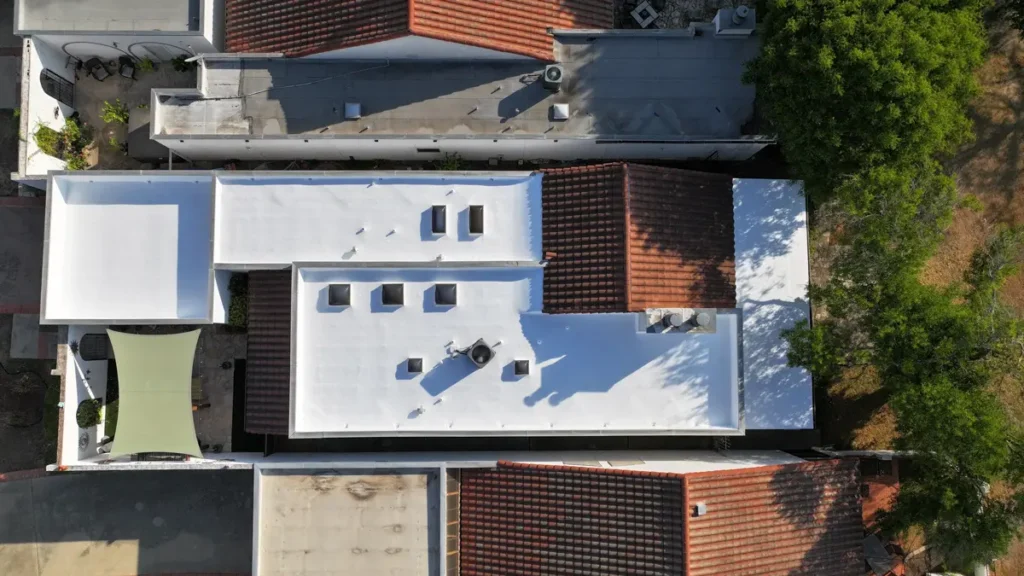 Overhead drone image of high-solids silicone top coat in Ure-A-Sil California roof restoration system.
