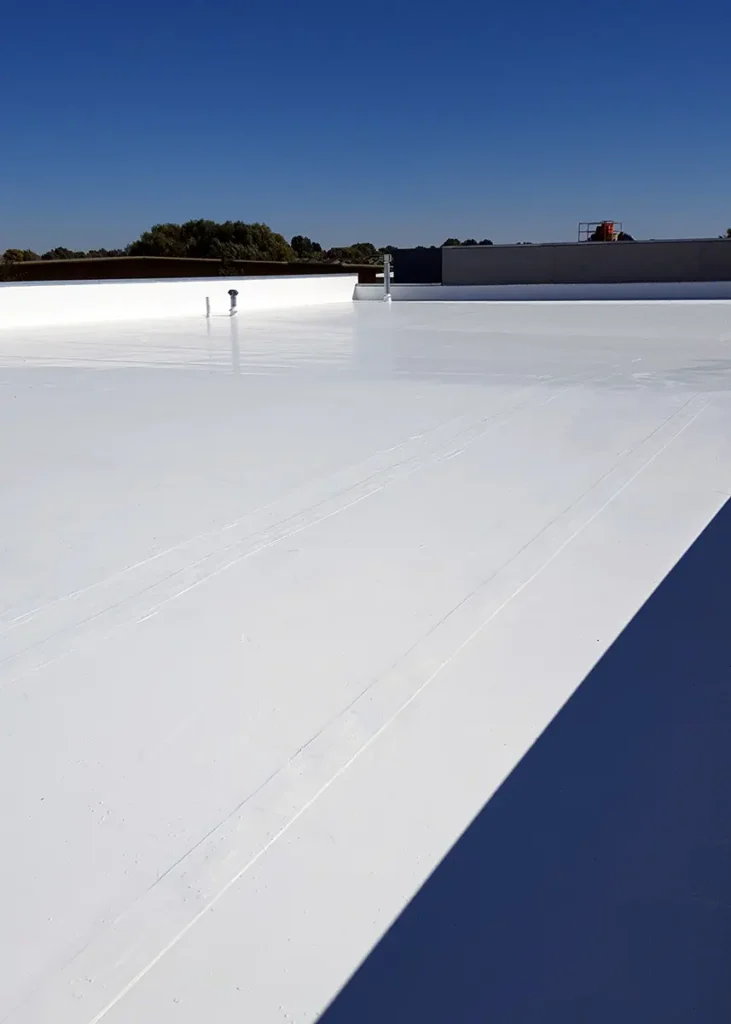 Image of Ure-A-Sil silicone top coat on EPDM commercial flat roof of retail center.