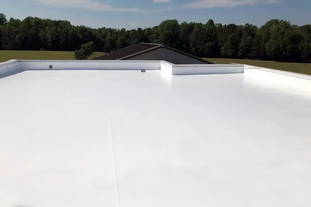 On-the-roof view of Ure-A-Sil silicone top coat with trees and soccer fields in the distance.