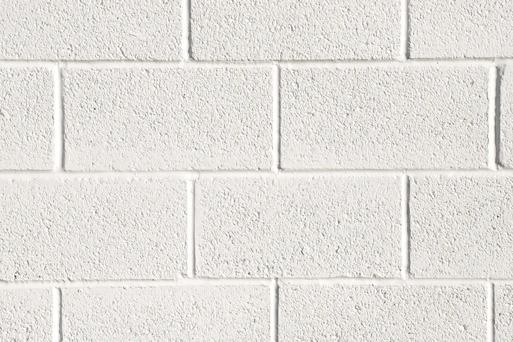 Close-up image of acrylic wall coating on cinder block wall showing the superior moisture protection and breathable design.