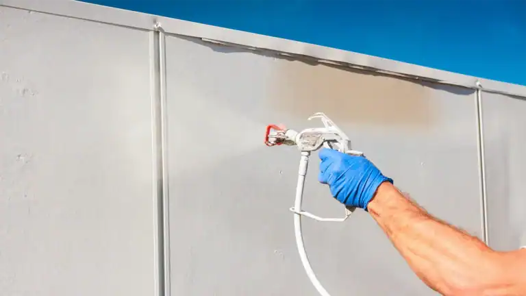 Contractor spraying wall coating