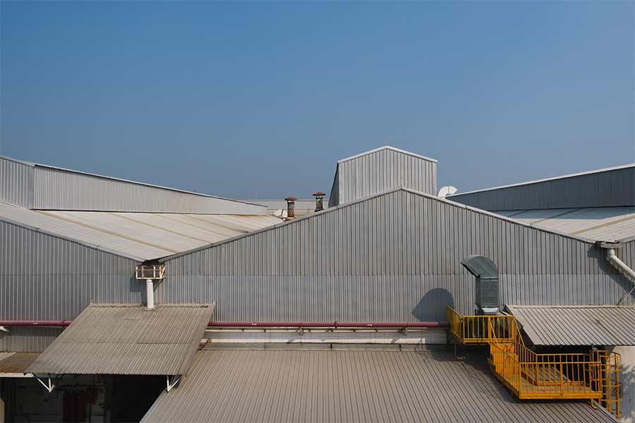 "Industrial building with a metal roof, providing a durable and weather-resistant surface designed for long-term protection and energy efficiency.