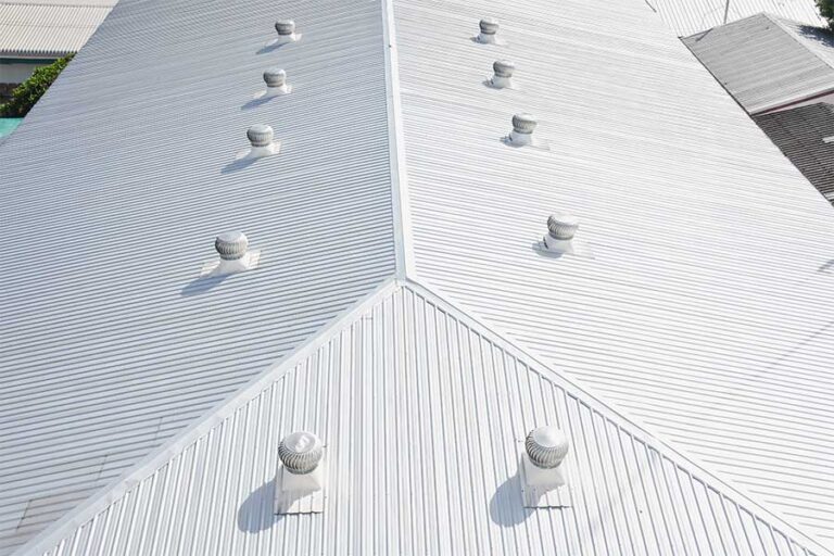 Reflective white commercial metal roof, showcasing its ability to reduce heat absorption and improve energy efficiency for the building.