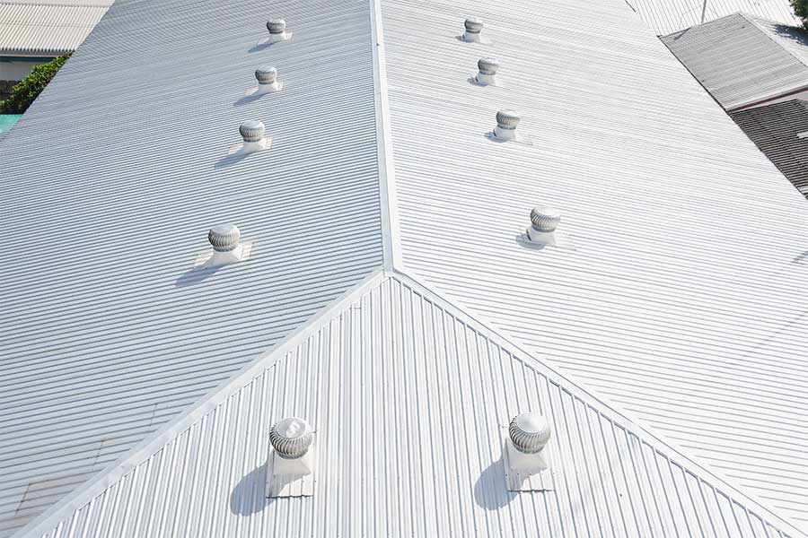 Reflective white commercial metal roof, showcasing its ability to reduce heat absorption and improve energy efficiency for the building.