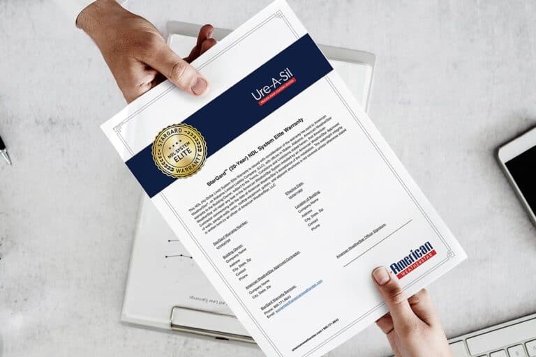 Image of one person handing over paperwork with roof warranty information, demonstrating the transfer of important documentation for roof system coverage and protection.