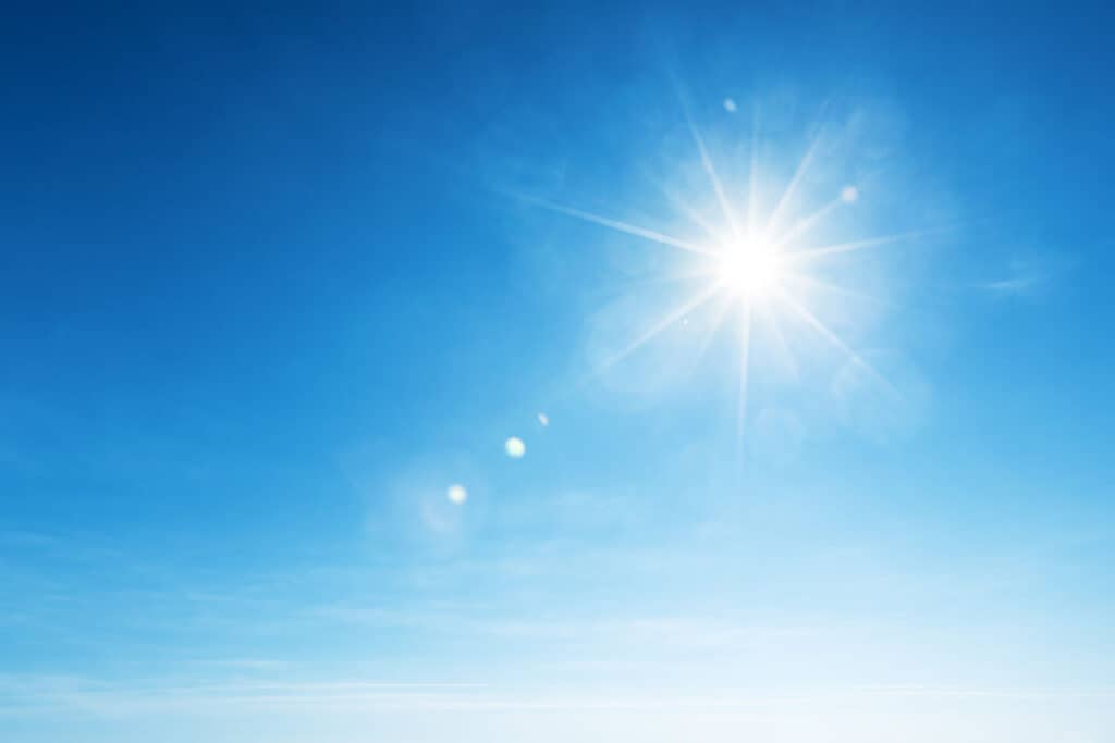 Picture of the sun beaming down, highlighting its powerful rays and the impact of solar energy on roofing and energy efficiency.