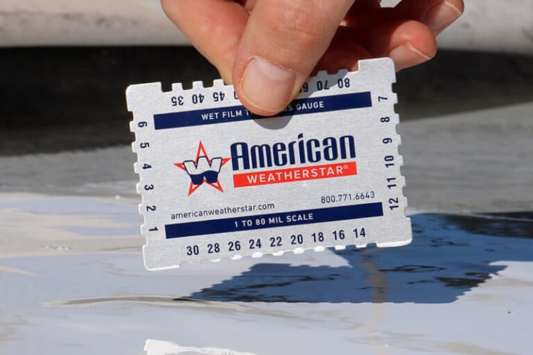 American WeatherStar branded wet mil gauge being used to check the wet mil thickness of roof coating, ensuring proper application for optimal performance and durability.