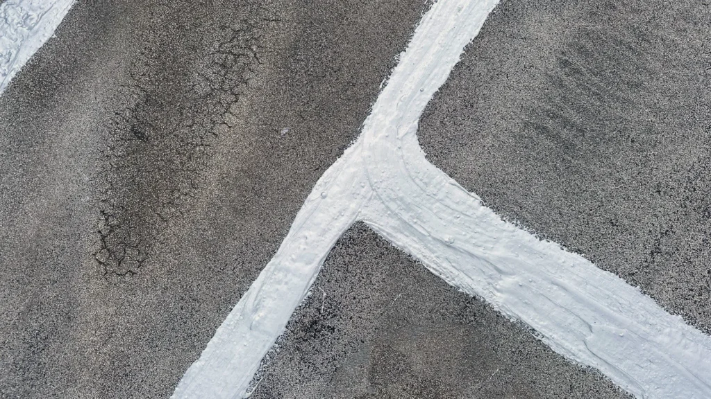 Urethane roof sealant on seams of granulated mod bit roof