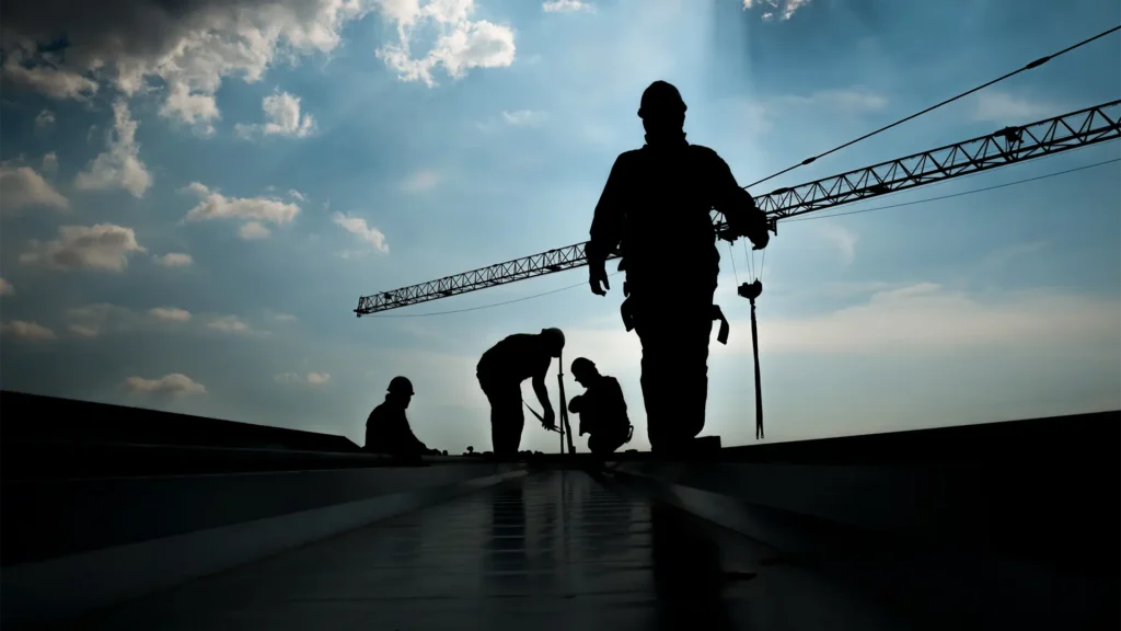 Commercial roofing contractors working on rooftop
