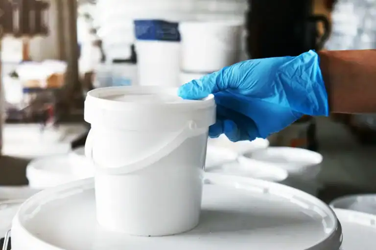Worker handling liquid coating samples