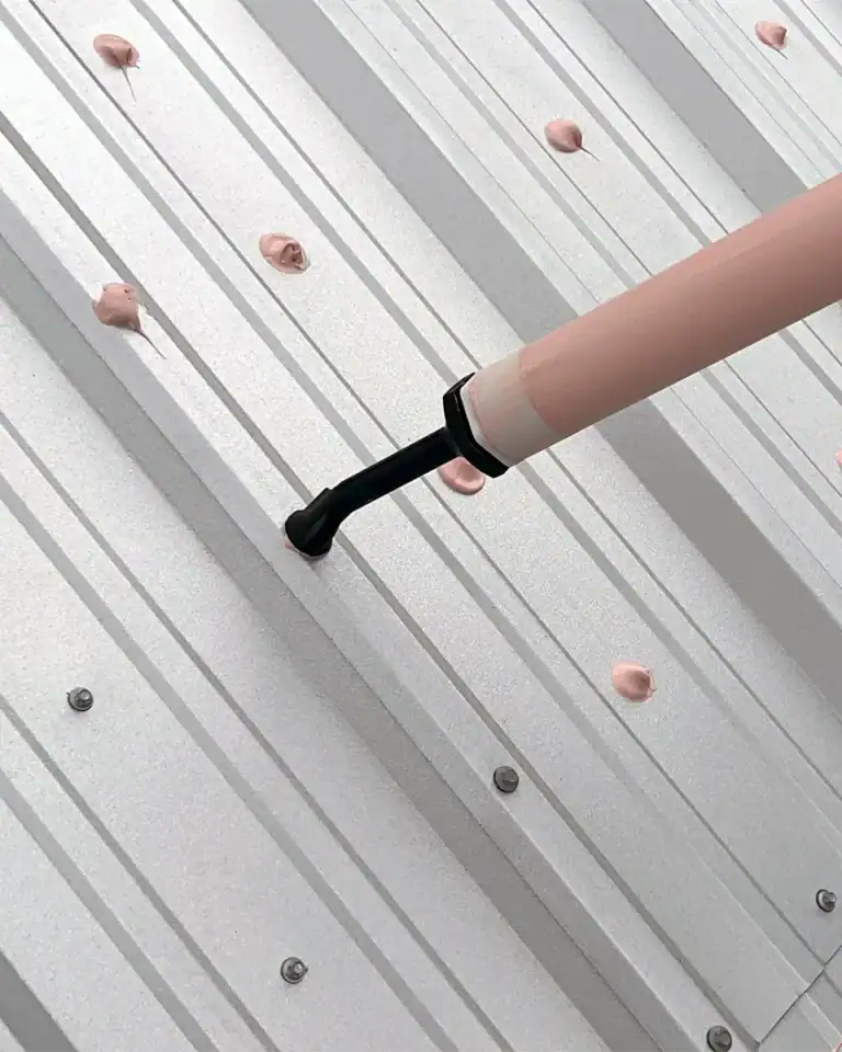 Acrylic sealant treating metal roof fasteners