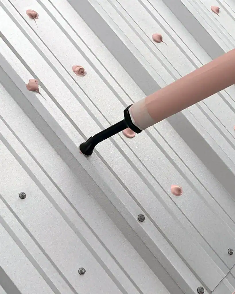 Acrylic sealant treating metal roof fasteners