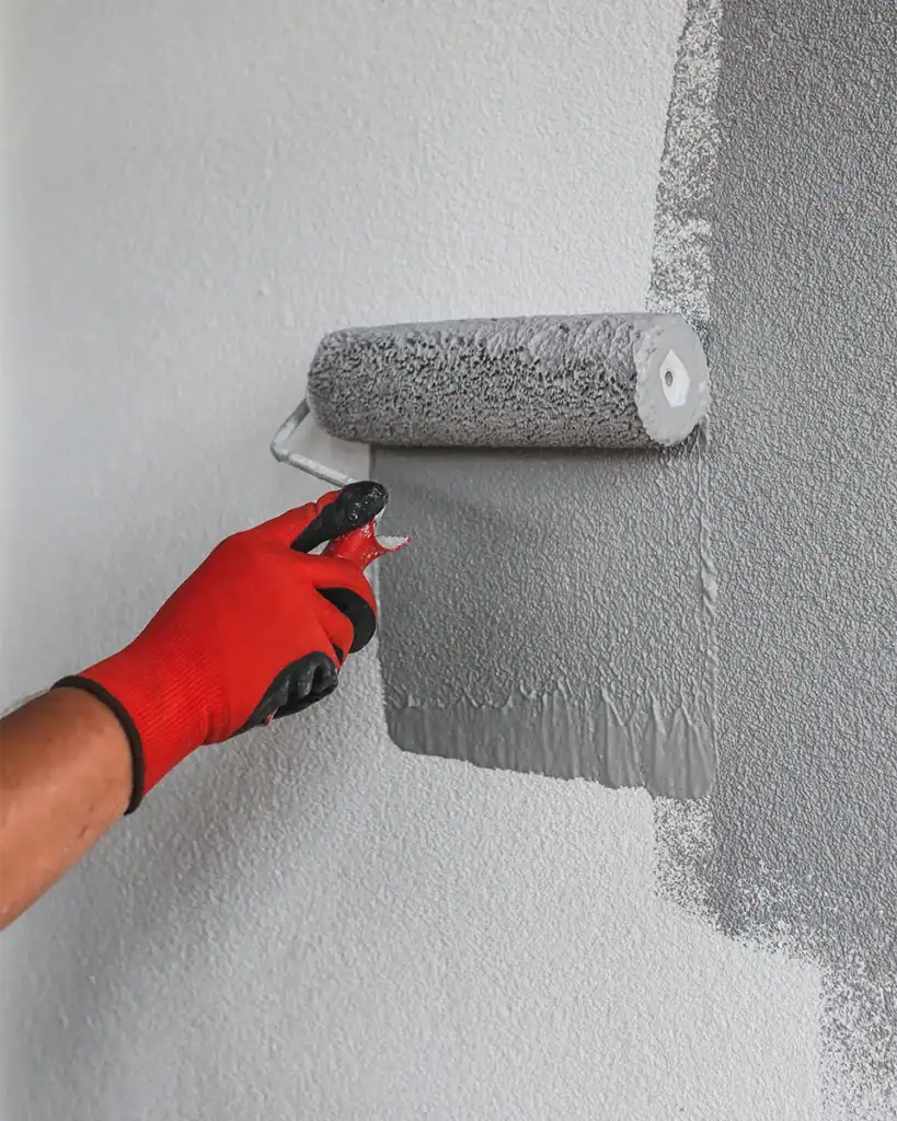 Man applying wall coating to masonry wall