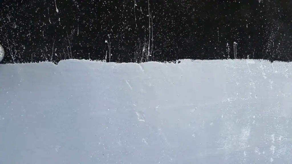 Close up up roof coating on black epdm roof