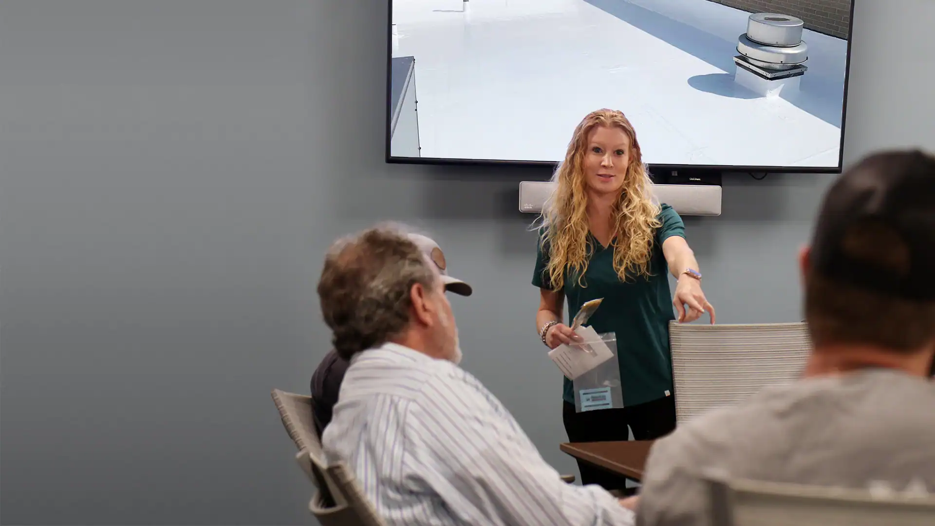 Rep meeting with customers in conference room