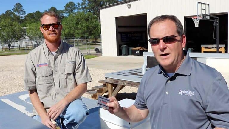 Eric Long and Scott Gayle showing how to use a wet mil gauge