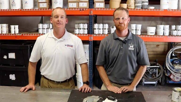 Brian O'Donnell and Eric Long discussing the results of an adhesion test
