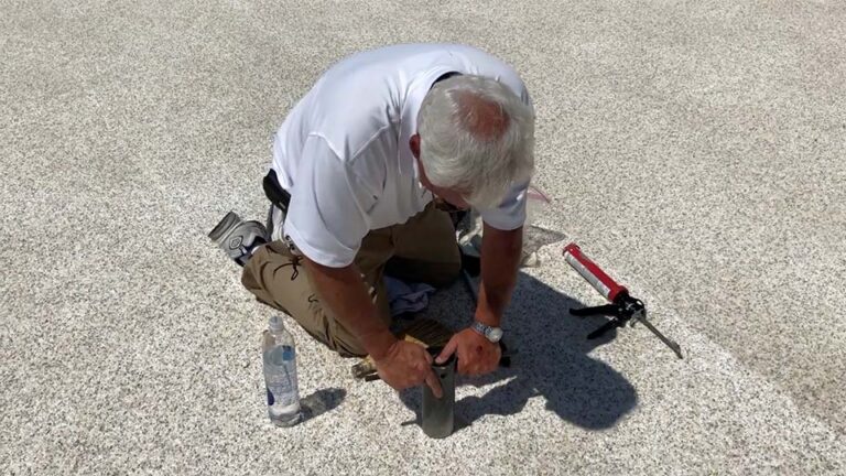 Roof inspector taking a core sample on a foam roof