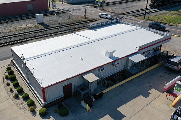 Aerial view of roof coating applied to roof of convenience store.
