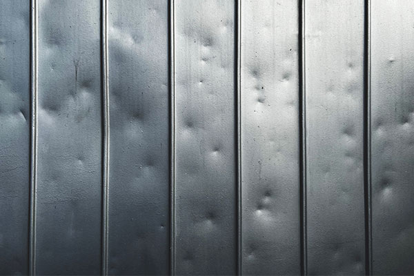 Hail damage seen on metal roof panels. 